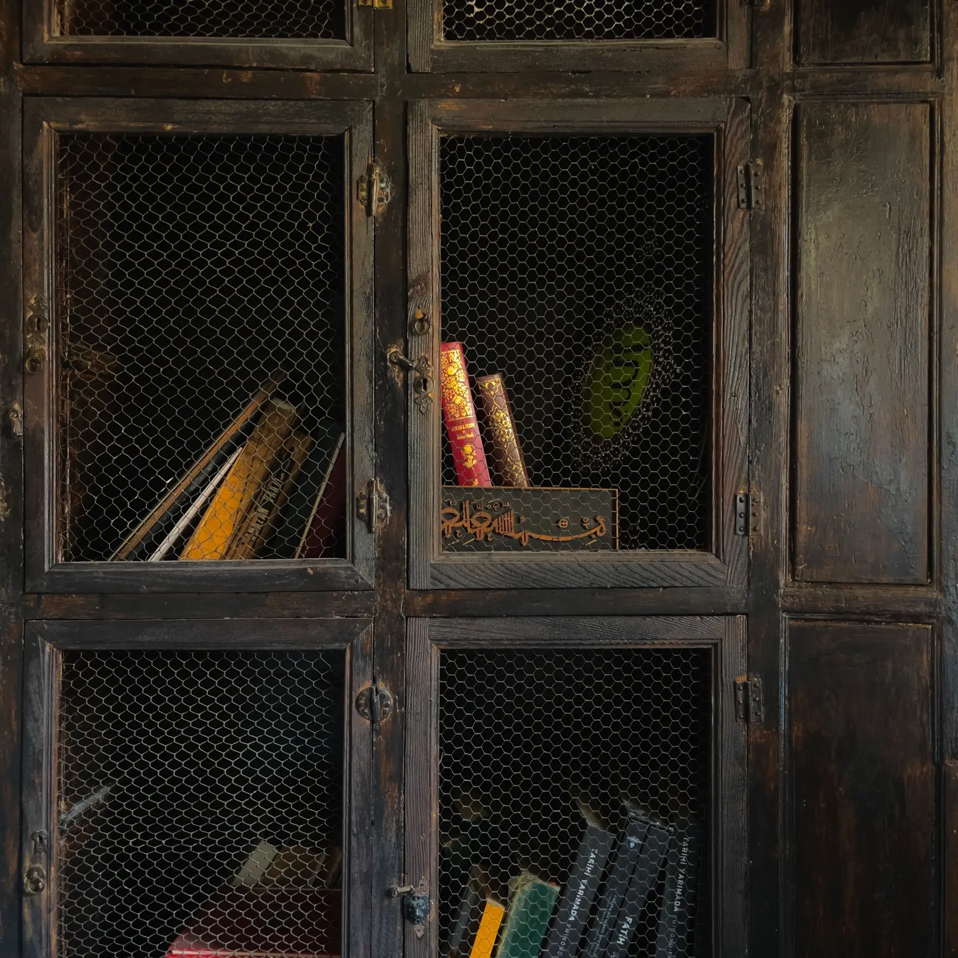 Wooden cabinet holding books and display pieces