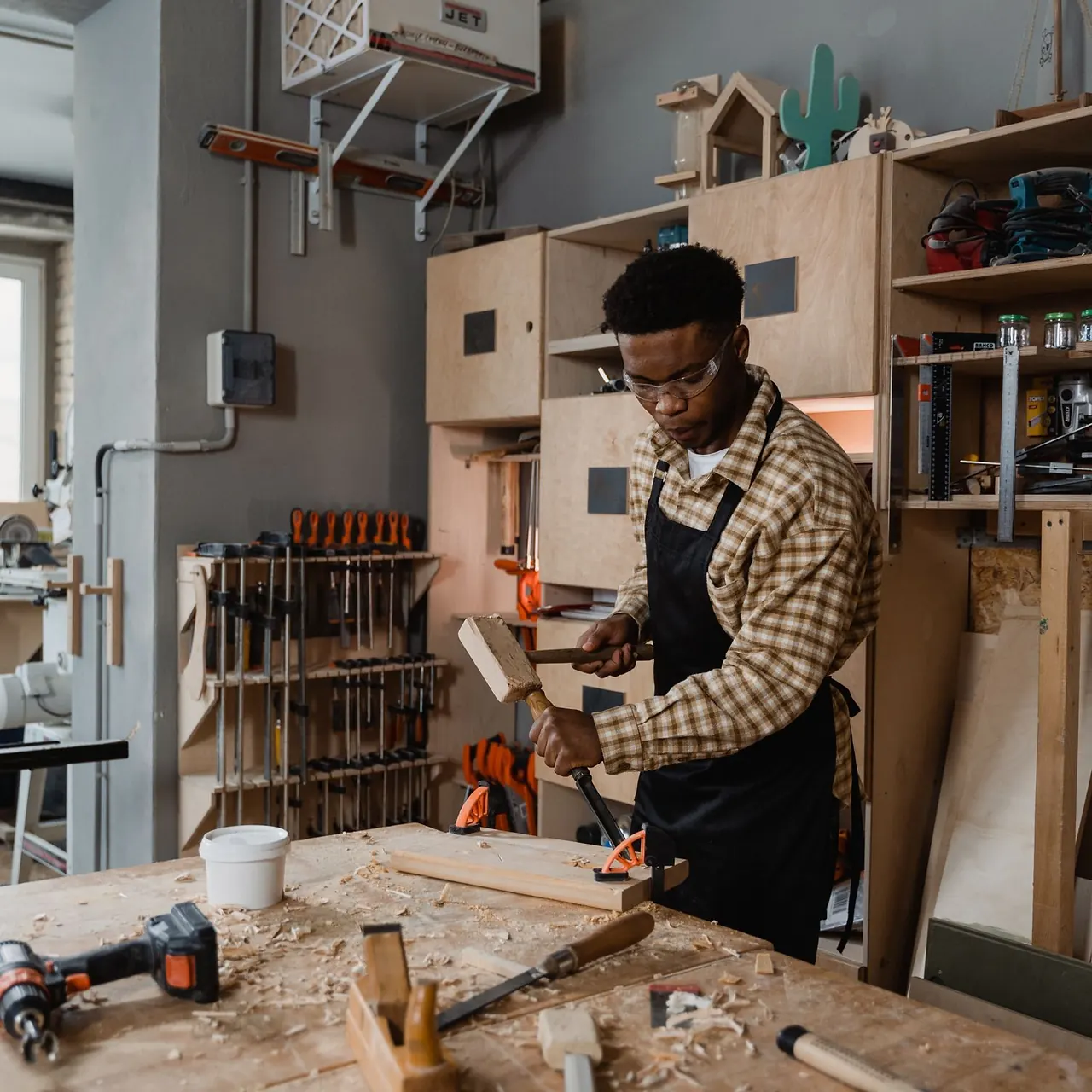 Carpenter shaping a wooden component by hand