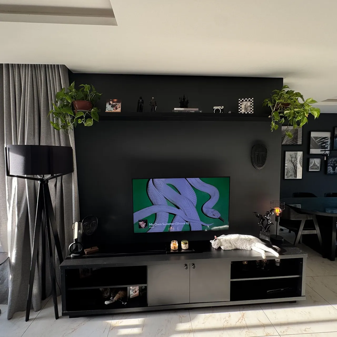 Low black television unit against a living room wall
