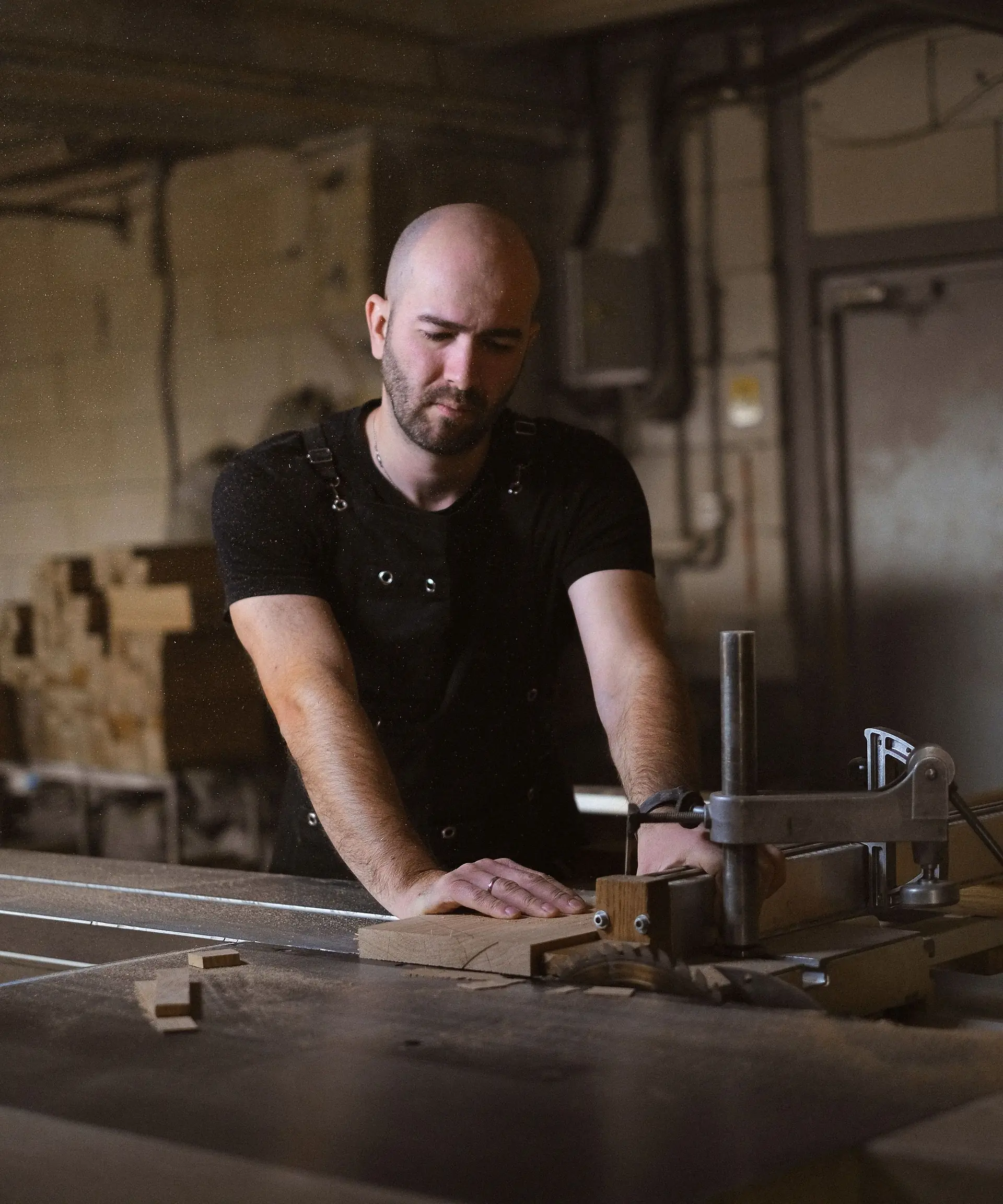 Craftsman working at a saw bench in a furniture workshop