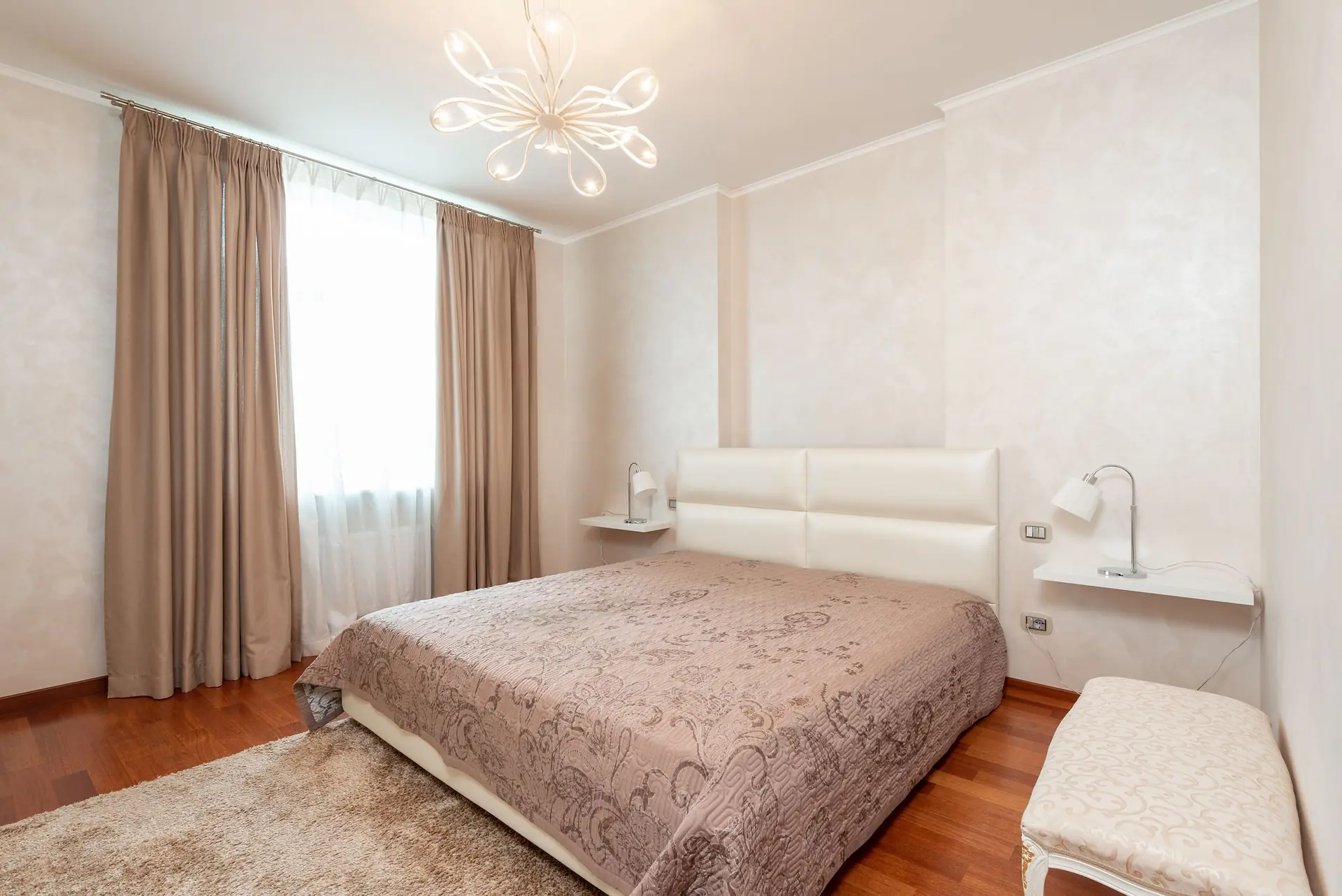 Bedroom with a comfortable bed and end-of-bed bench