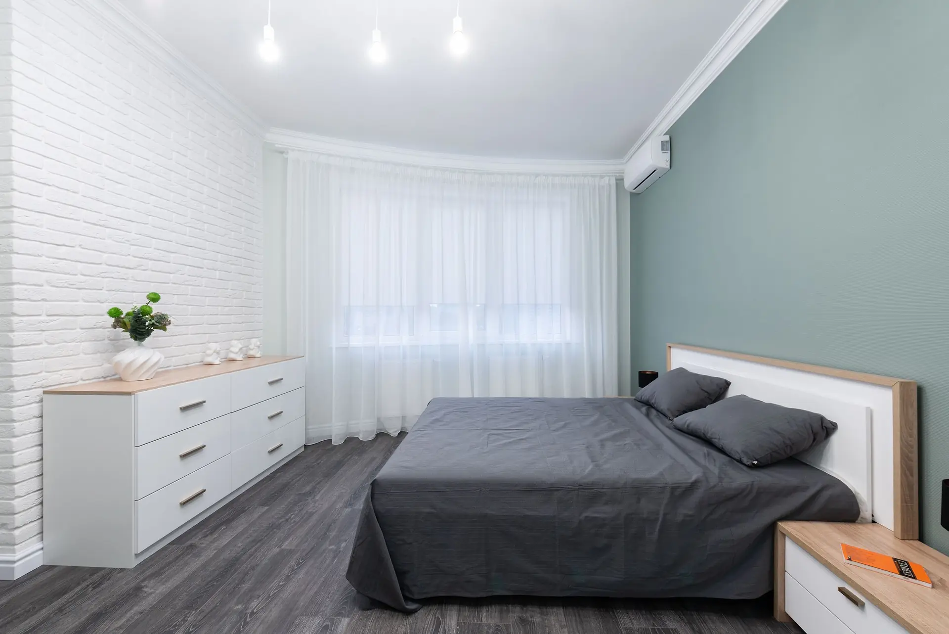 Bedroom furniture lit by warm bedside lamps