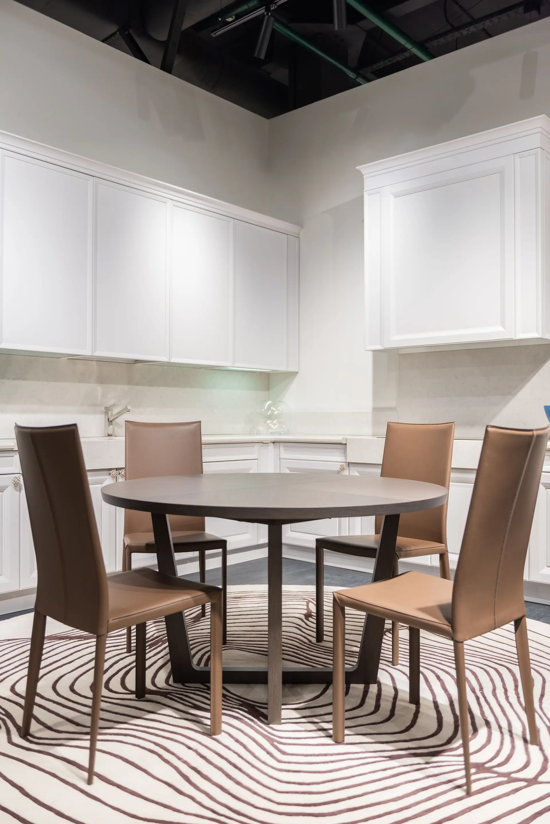 Kitchen with a dining table and fitted cabinetry