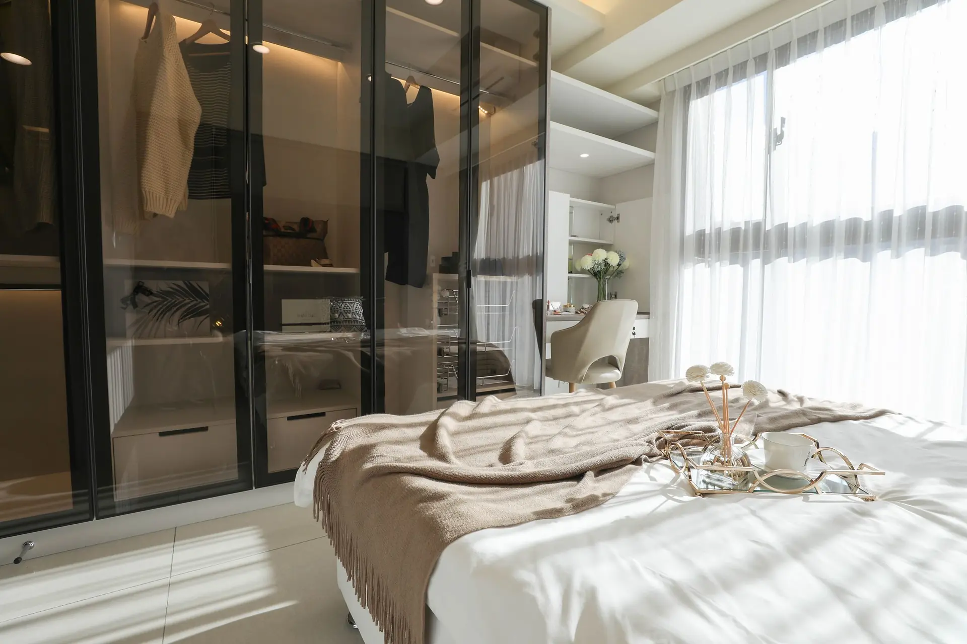 Bedroom with glass-fronted wardrobe cabinets