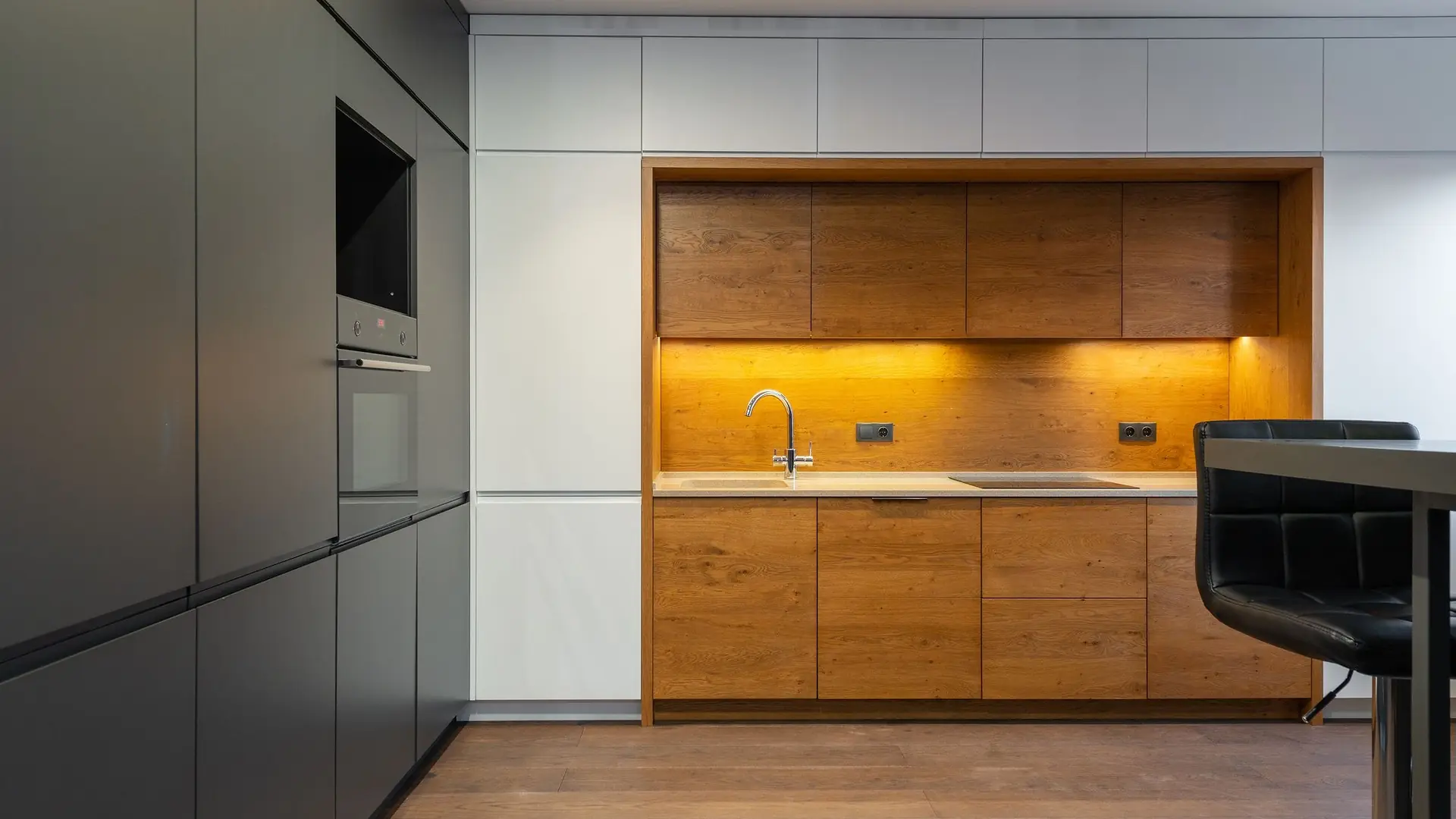 Large contemporary kitchen with full-height cabinetry and a stone worktop