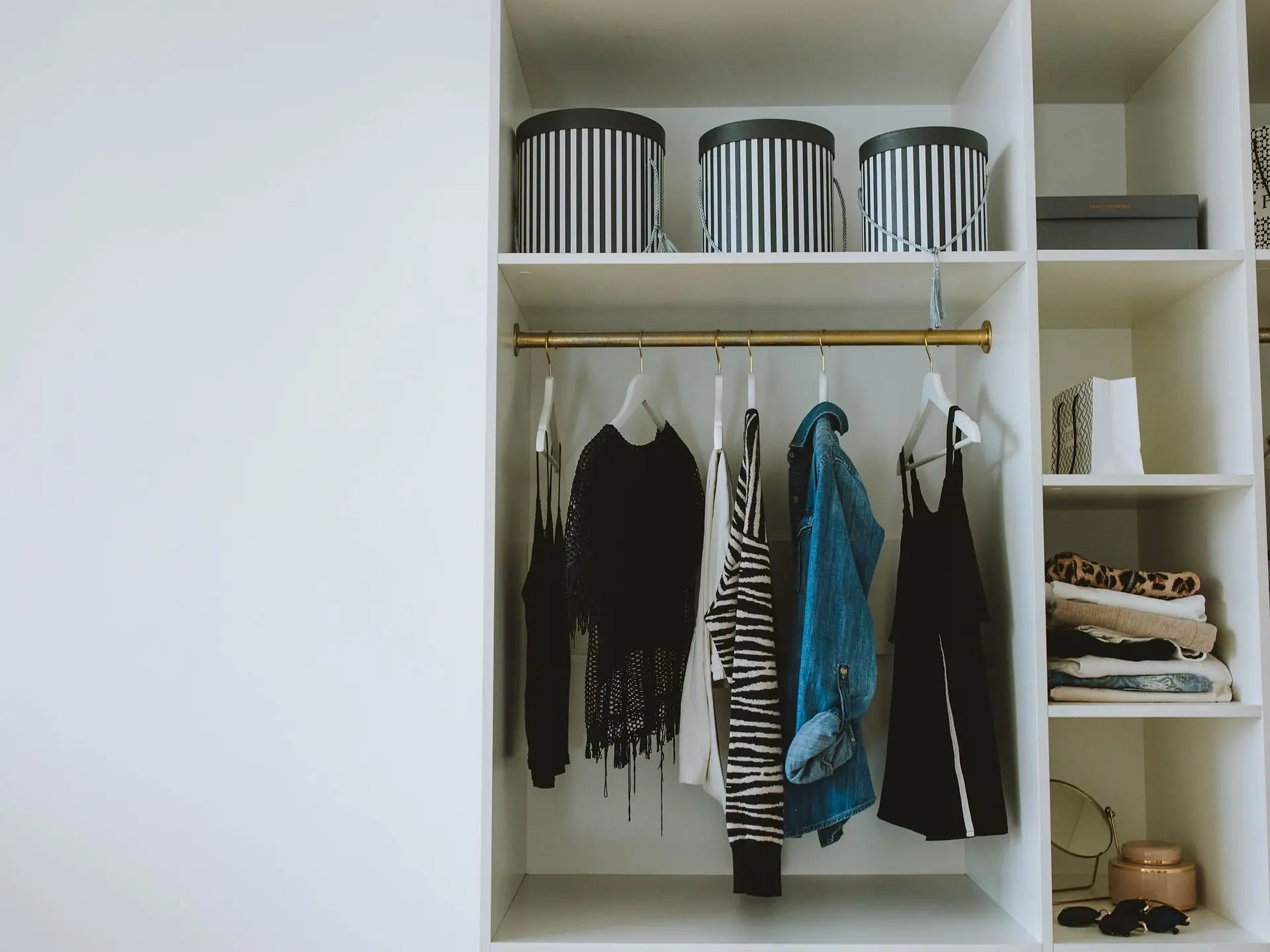 White wooden cabinet with hanging garments