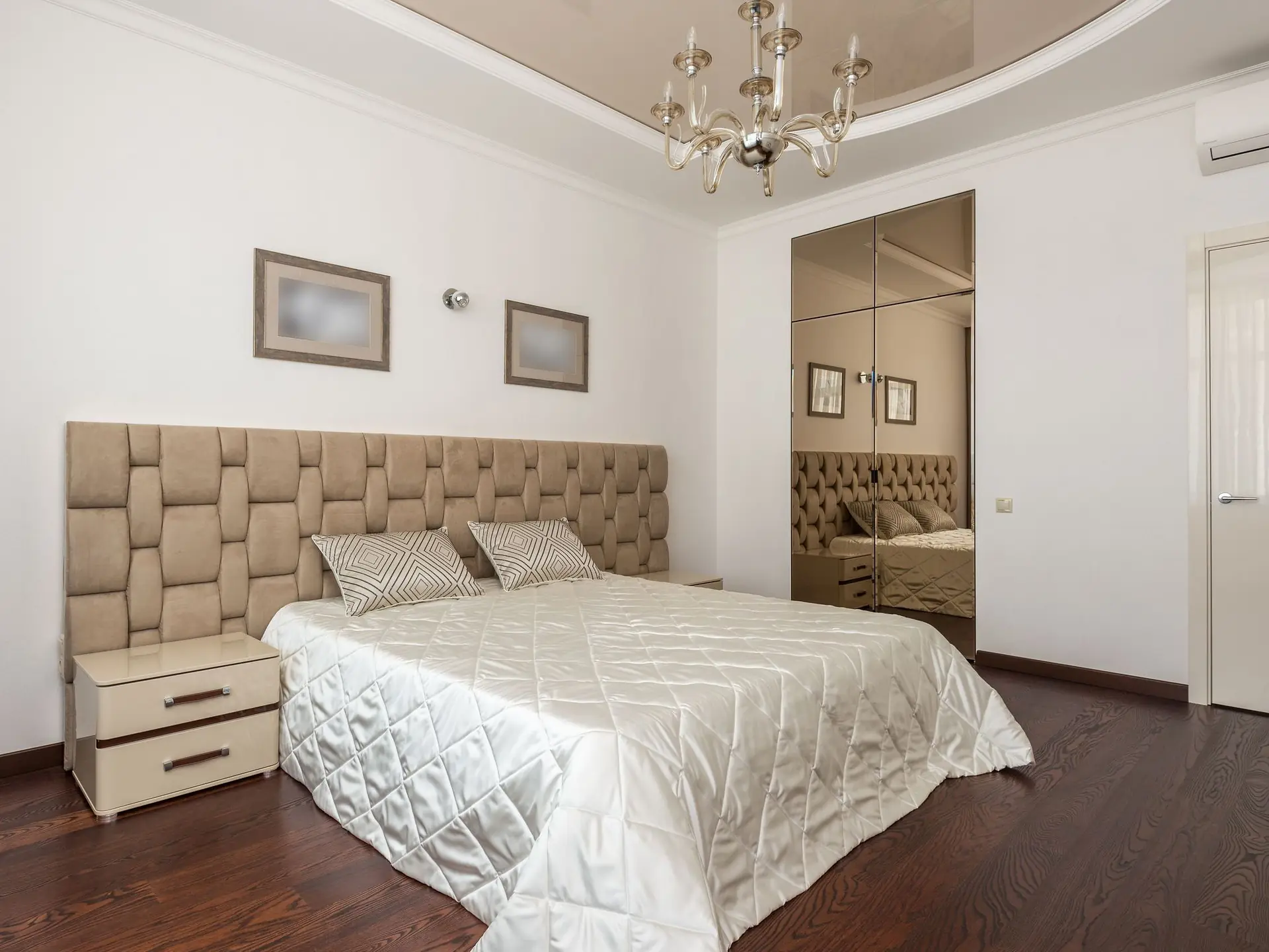 Double bed with a padded brown headboard