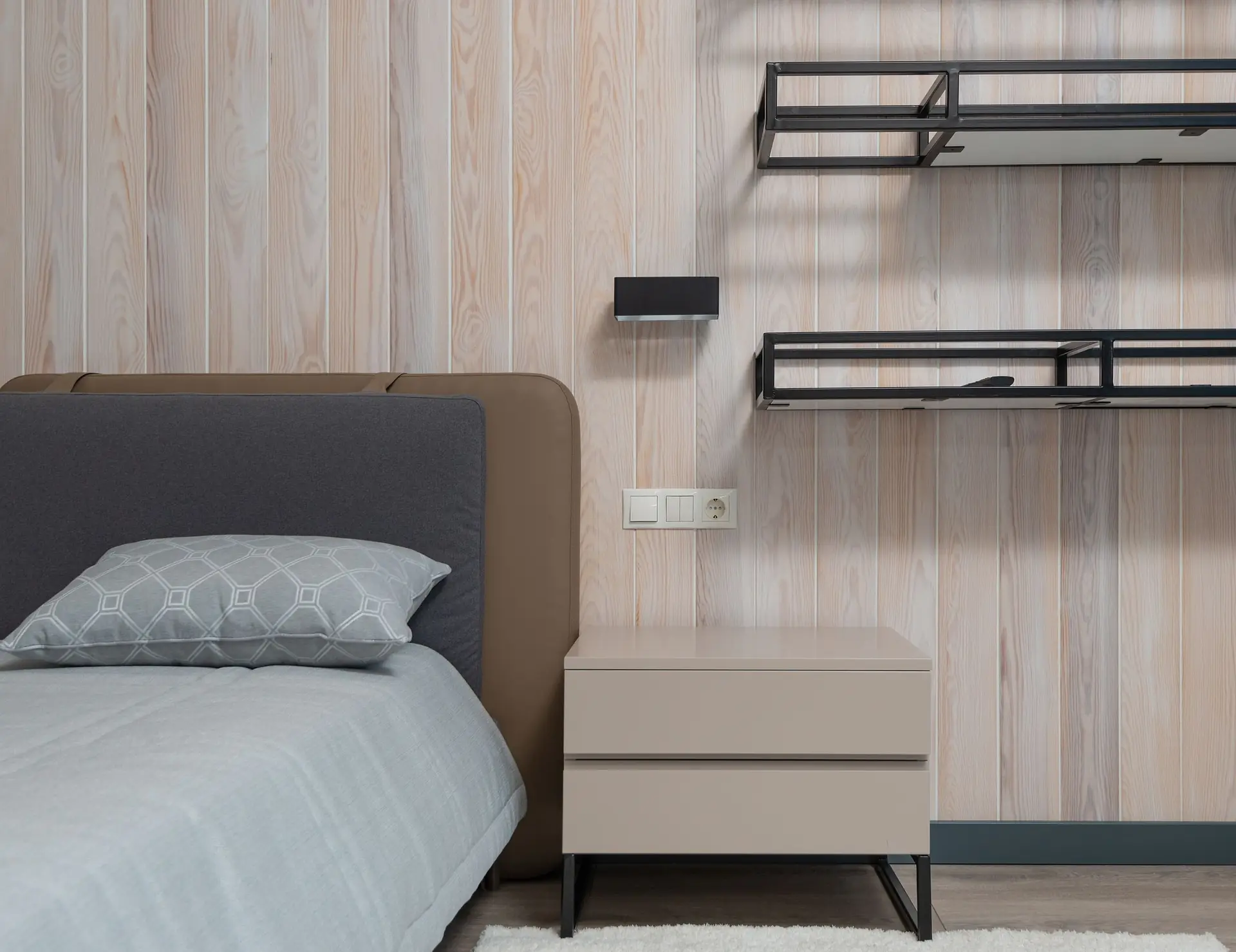 Bedside table and shelving in a cosy bedroom