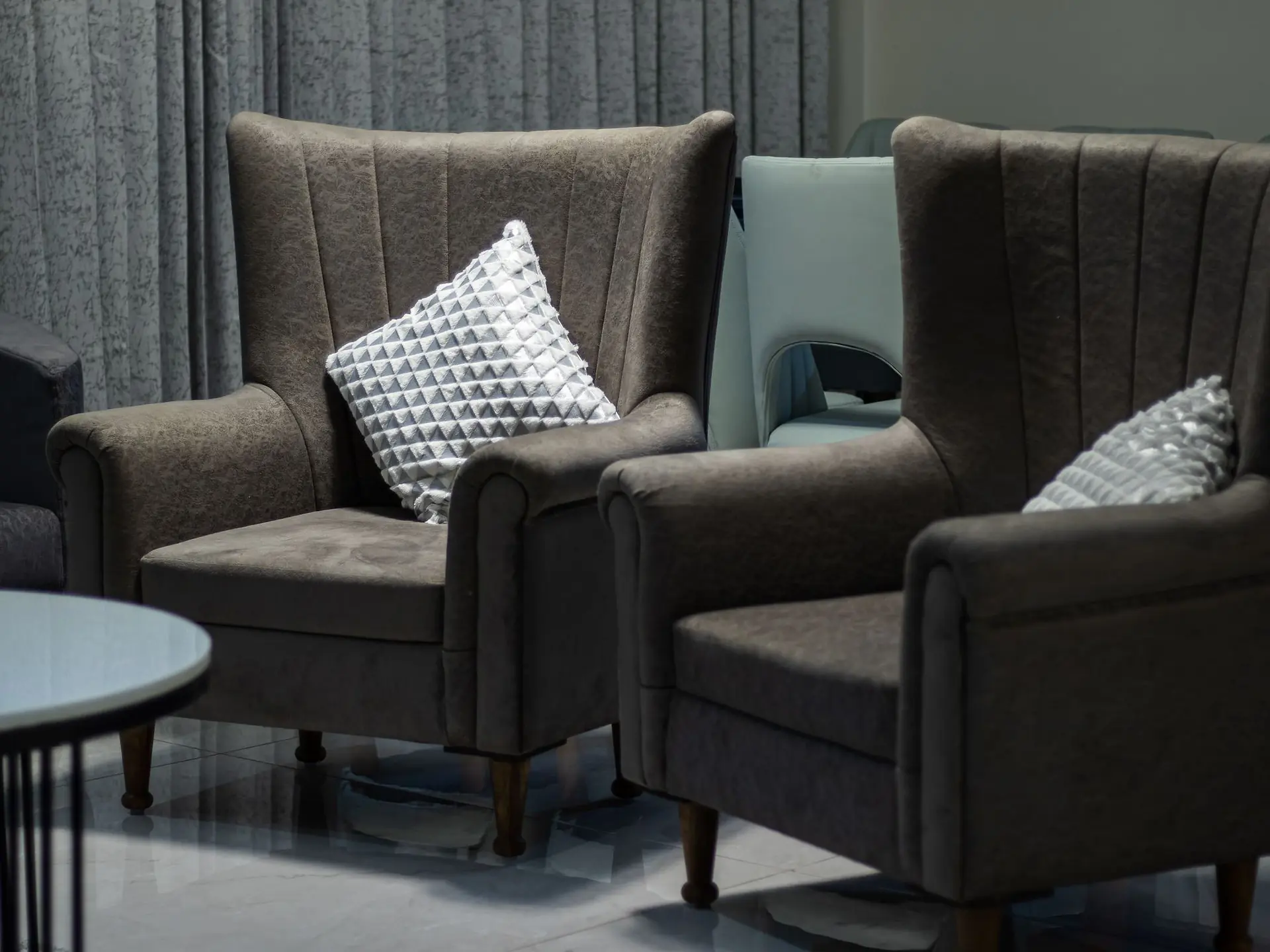 Soft armchairs with cushions side by side
