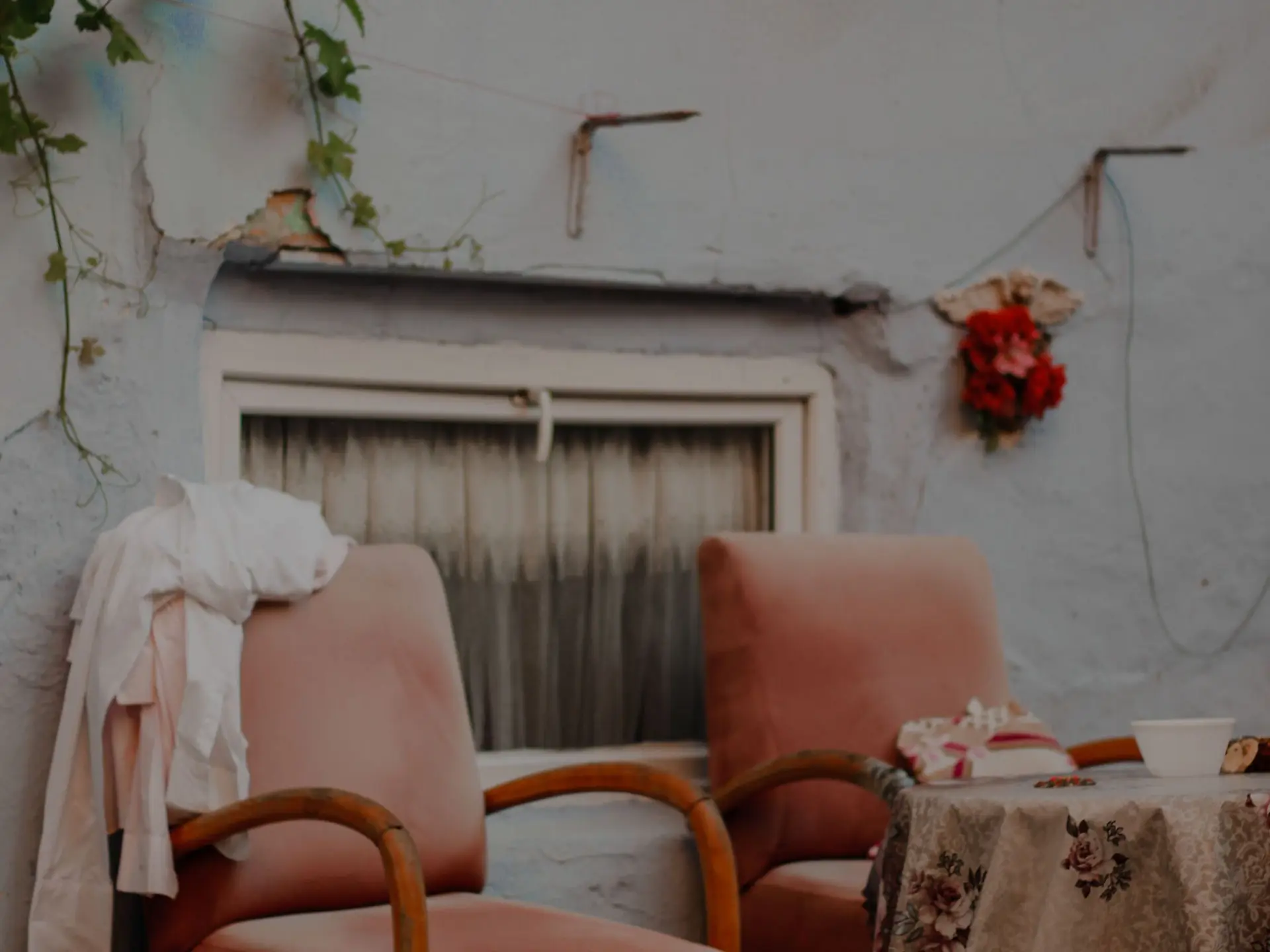 Pair of armchairs beside a window and concrete wall