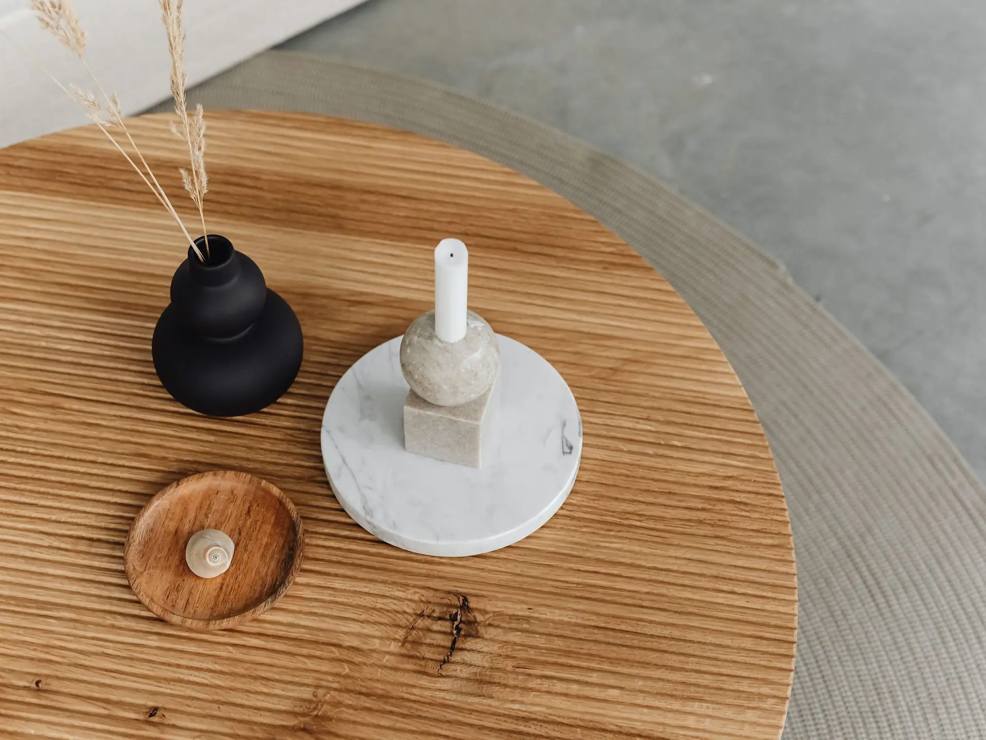 Coffee table styled with a candle and vase