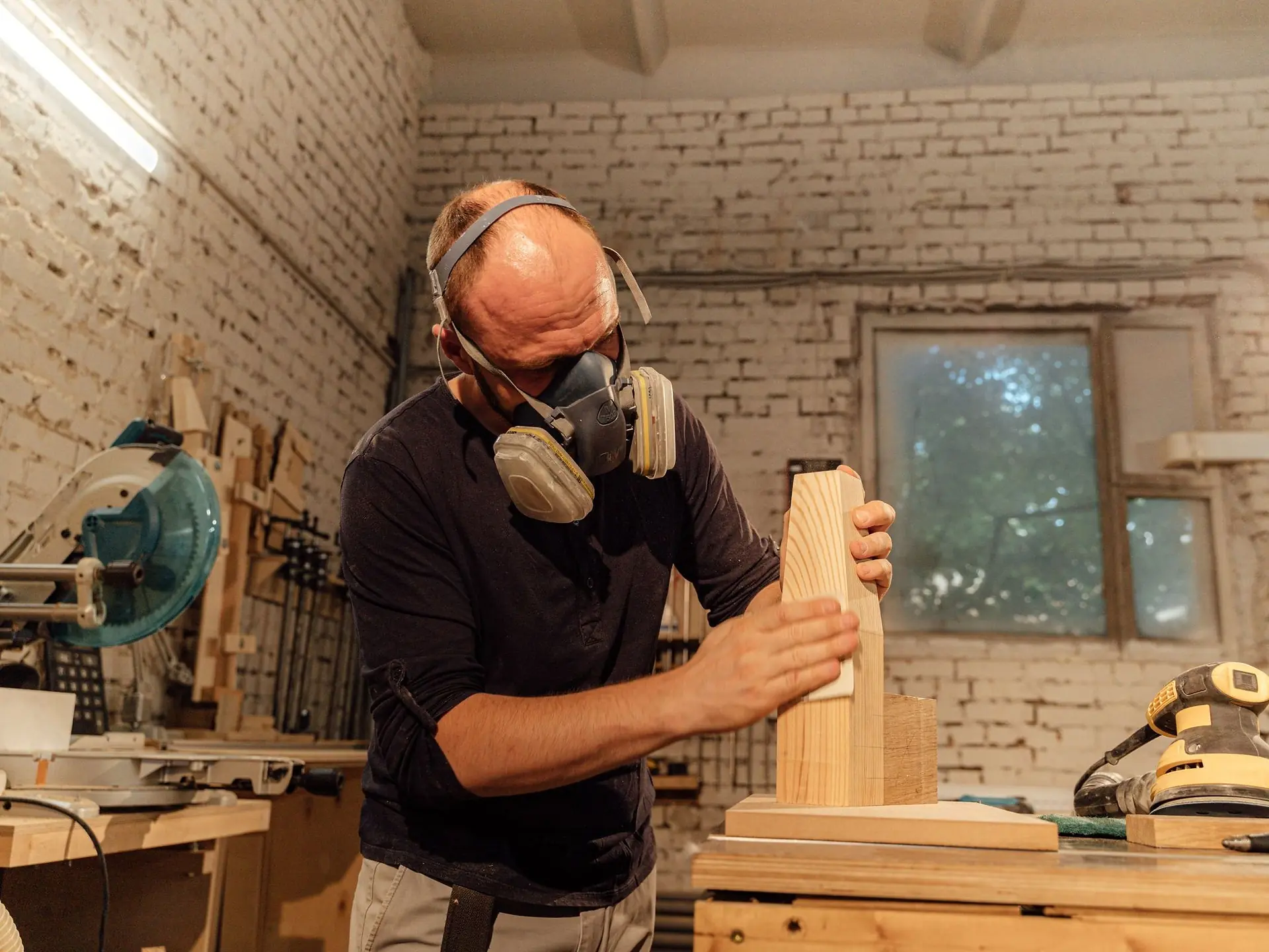 Craftsman holding a prepared wooden plank