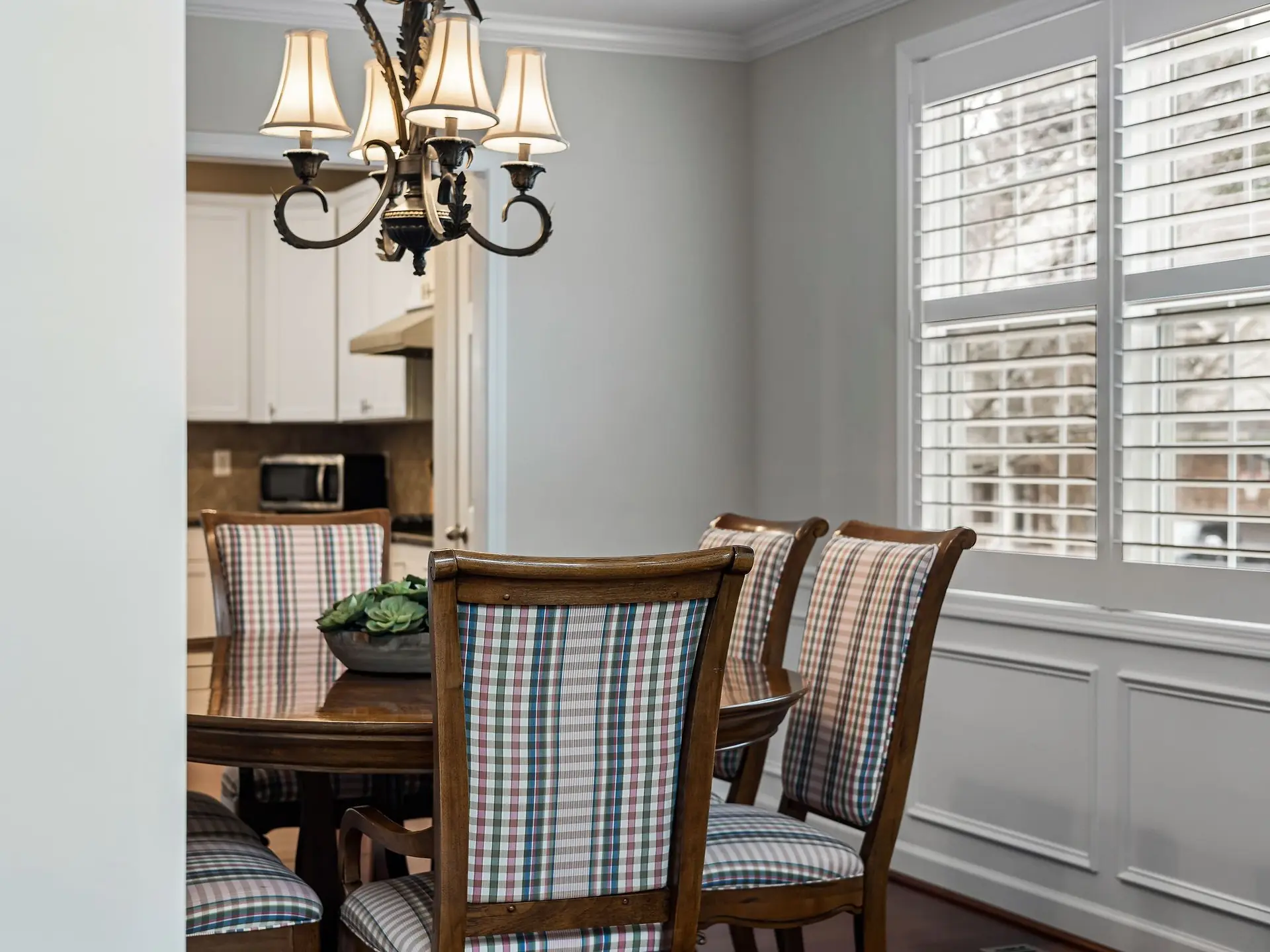 Dining table and chairs beside a window