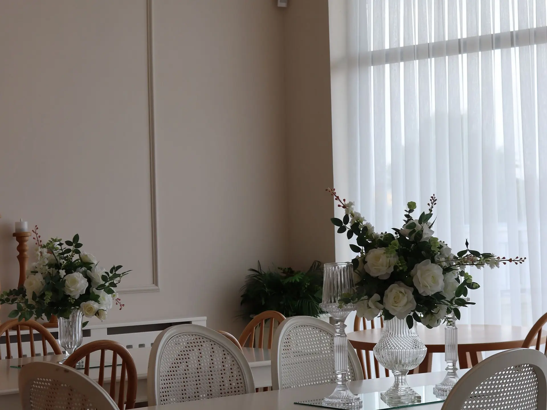 Formal dining room with a long table and floral centrepiece