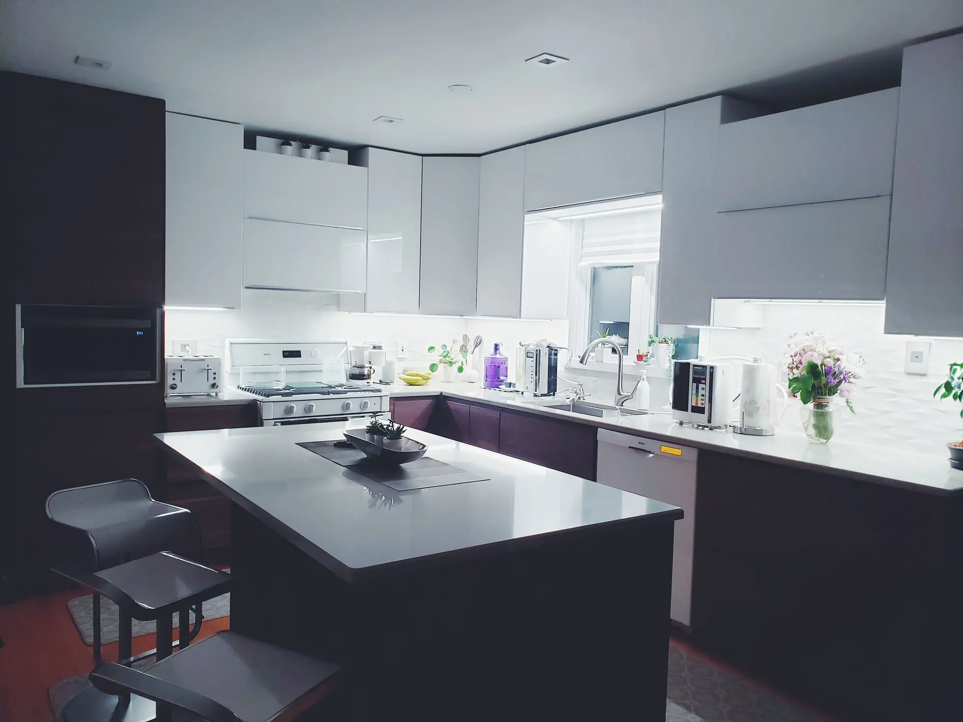 White kitchen island with a stone worktop