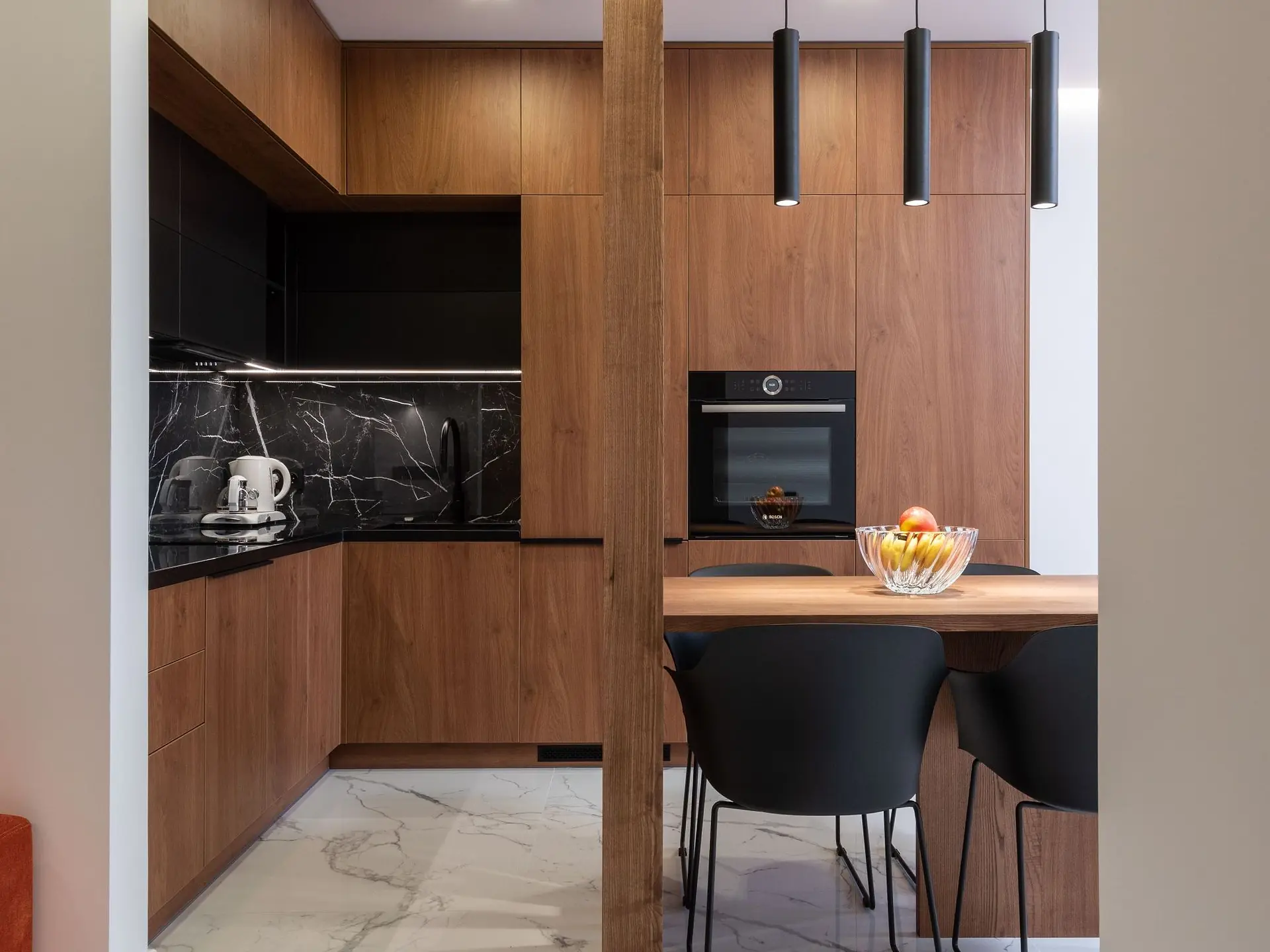 Kitchen with a wooden dining zone and fitted units