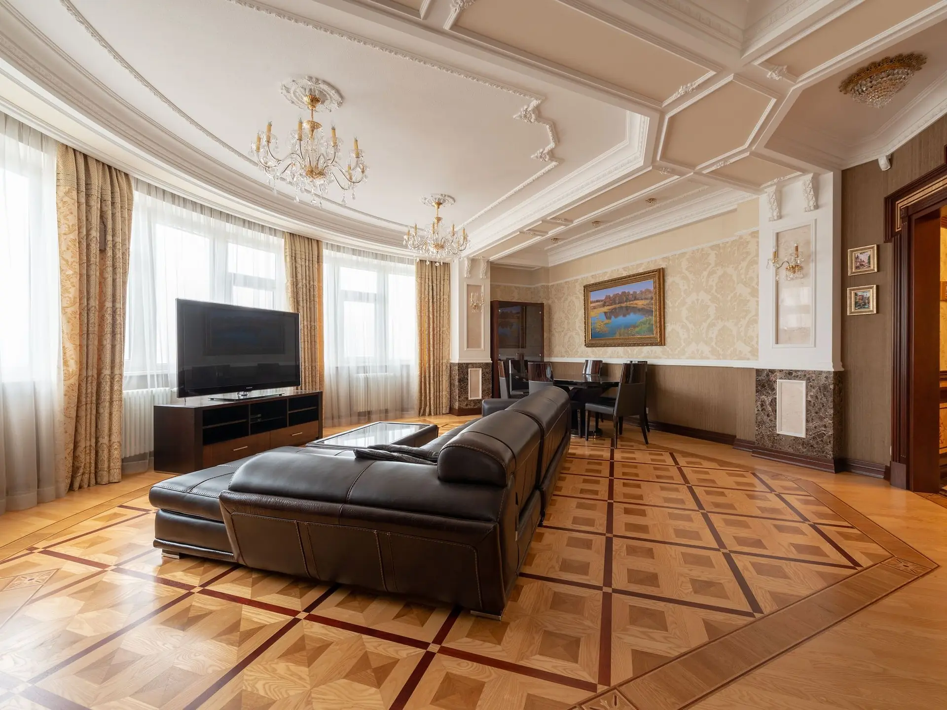 Black leather sofa against a light living room wall