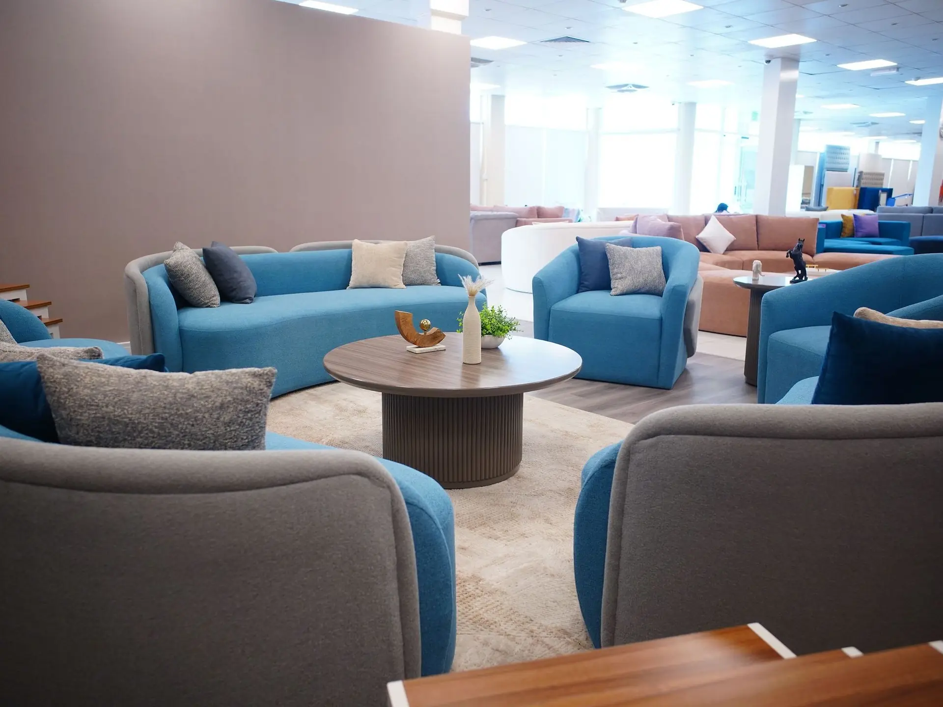 Blue upholstered sofa set arranged in a lounge
