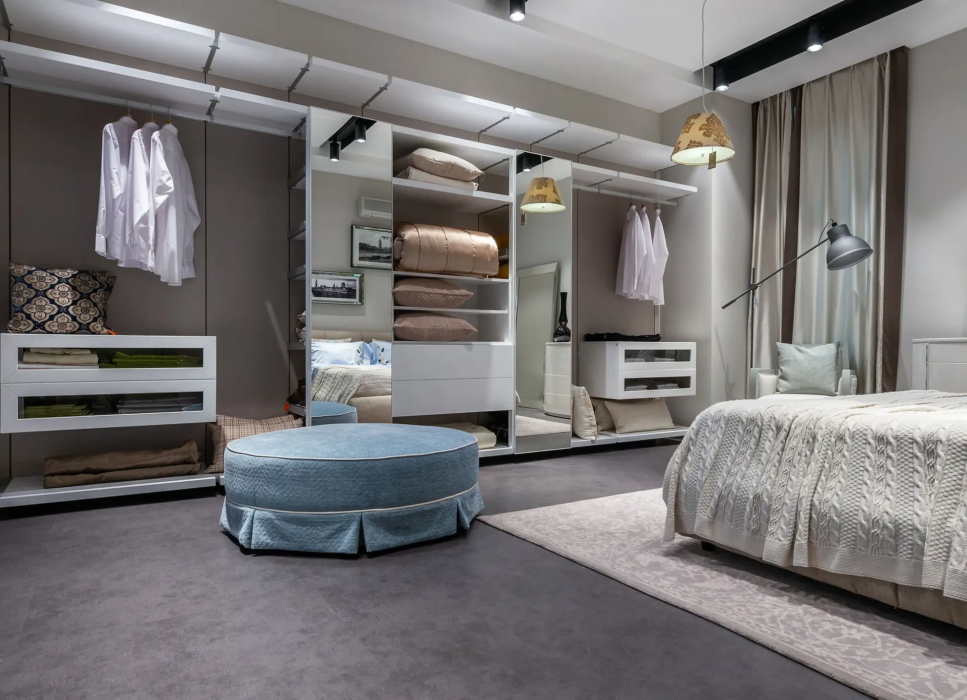 Built-in bedroom wardrobe with flush doors and a padded stool
