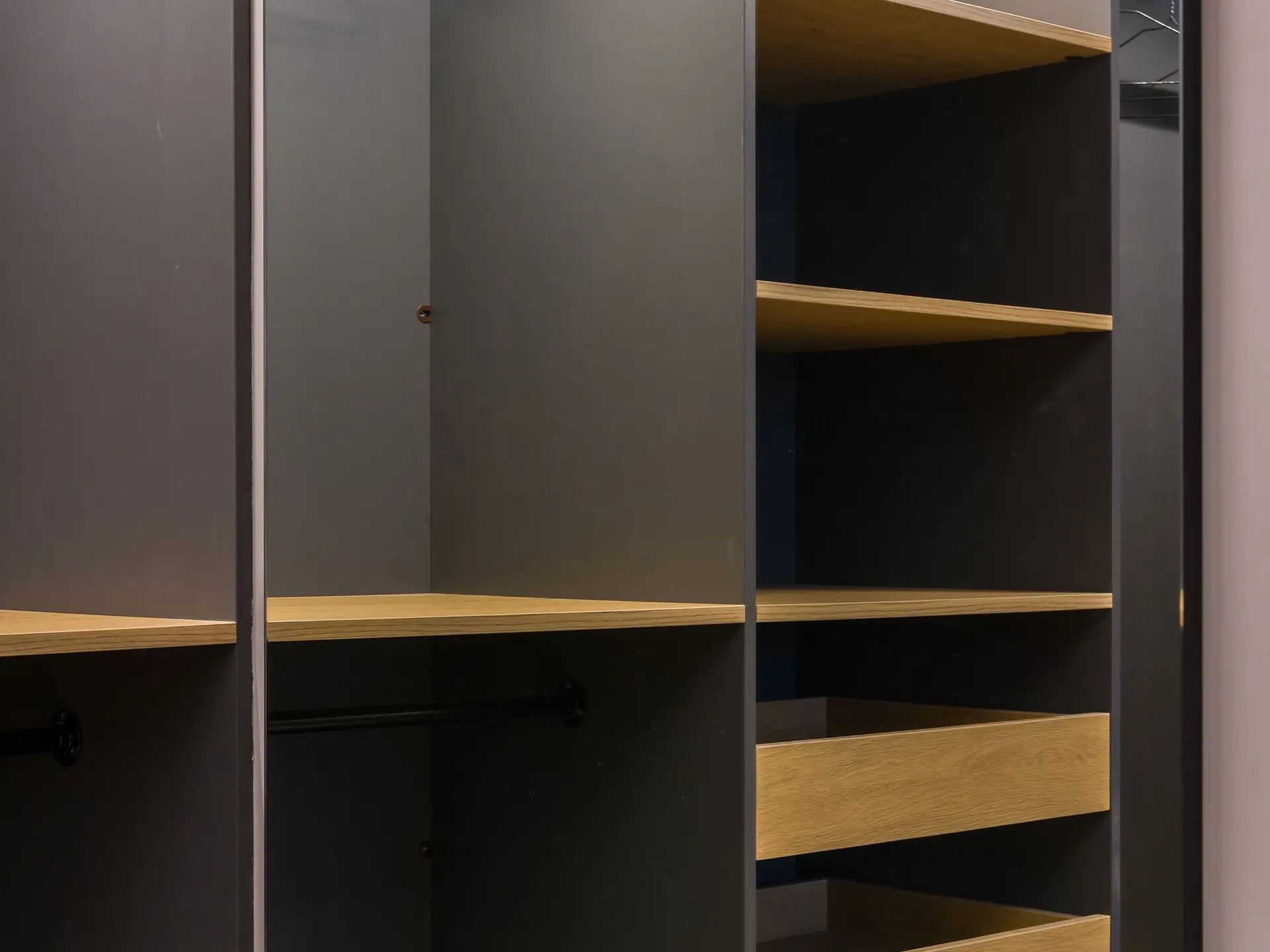 Wardrobe interior with hanging rails and folded storage