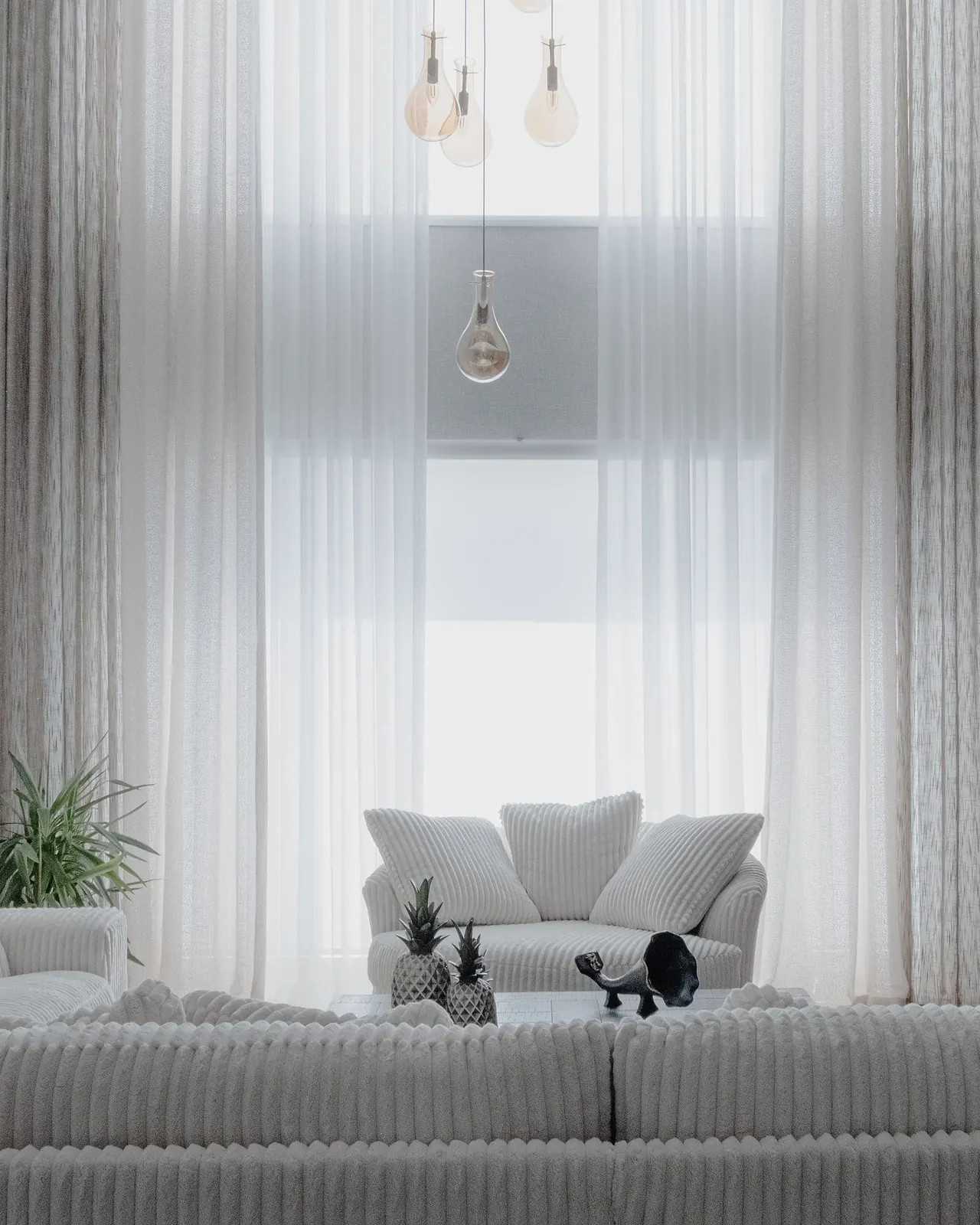 Bright living room with a soft white sofa and neutral furnishings