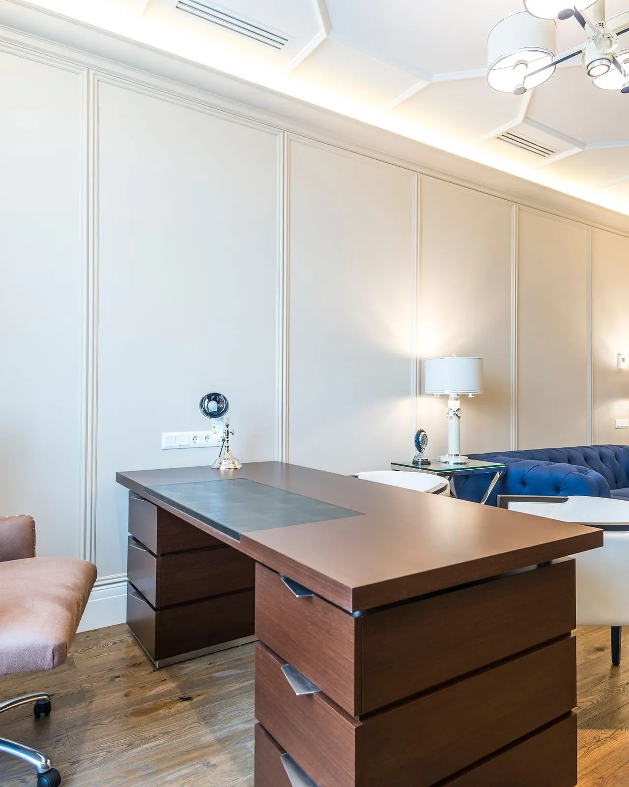 Home office with a wooden desk, shelving and a leather chair